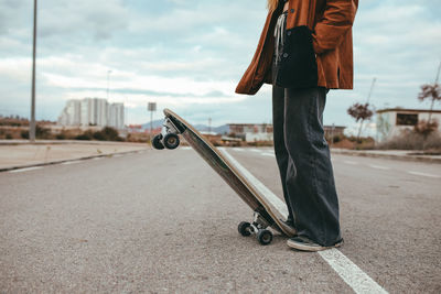 Low section of man standing on road