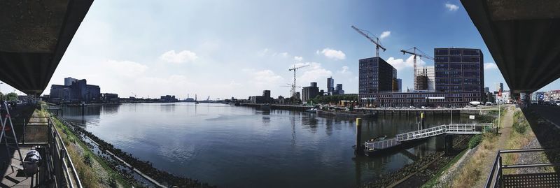 Panoramic view of river and buildings against sky