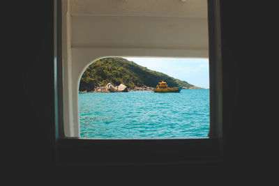 Close-up of sea seen through window