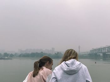 Rear view of woman looking at view against sky