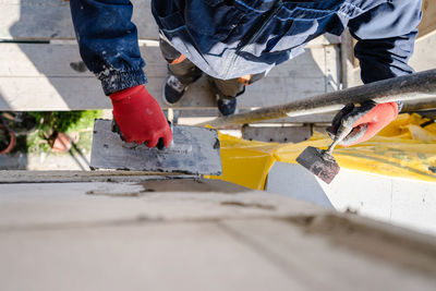 Low section of man working on wood