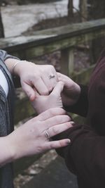 Midsection of couple holding hands