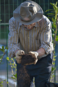 Man wearing bird outdoors