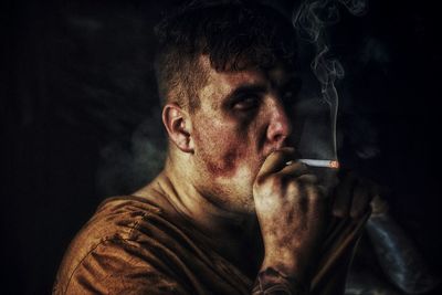 Portrait of man smoking cigarette