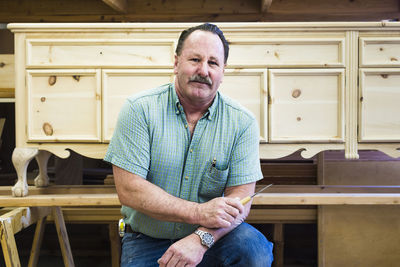 Portrait of confident carpenter at workshop