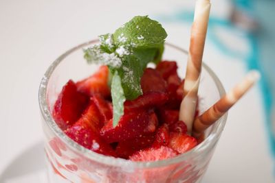 Close-up of strawberry holding ice cream in bowl