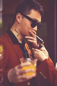 Portrait of young man drinking glass