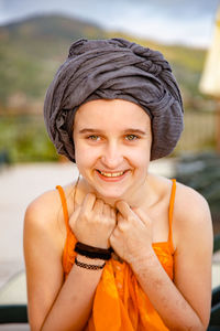 Portrait of smiling teenage girl wearing headscarf