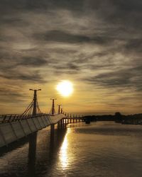 Bridge over sea during sunset