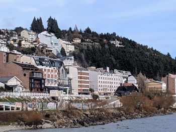 Buildings in town against sky