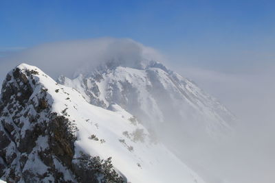 Scenic view of snowcapped mountains against clear sky