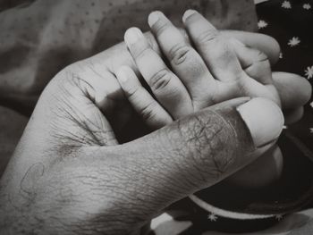 Cropped hands of man and baby