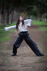 Side view of woman standing on field