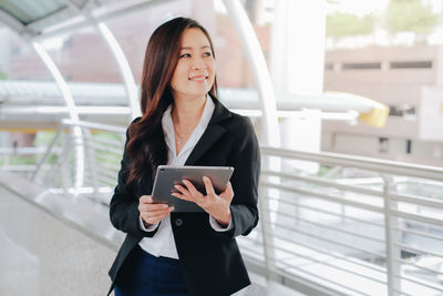 Portrait of young woman using mobile phone