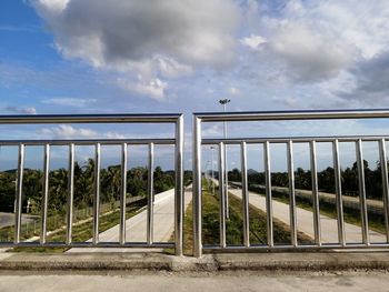 Built structure by railing against sky