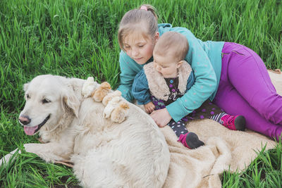 Portrait of boy playing with dog