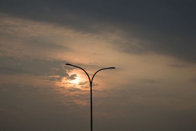 Low angle view of street light against sky during sunset