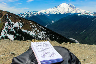 Scenic view of snowcapped mountains with someone writing blog