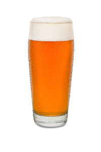 Close-up of beer glass against white background