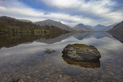 Scenic view of rocks in lake against sky