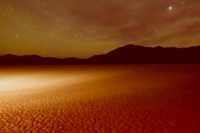 Scenic view of mountains against sky during sunset