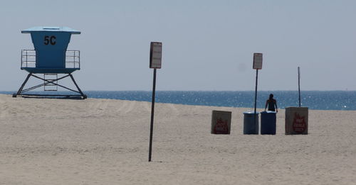 Scenic view of lifeguard hut on beach against clear sky