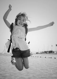 Portrait of young woman standing in lake