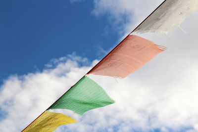 Low angle view of colorful flags against sky