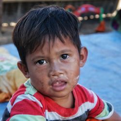 Close-up portrait of boy with dirty face outdoors