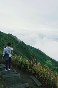 Full length of man standing on landscape against sky