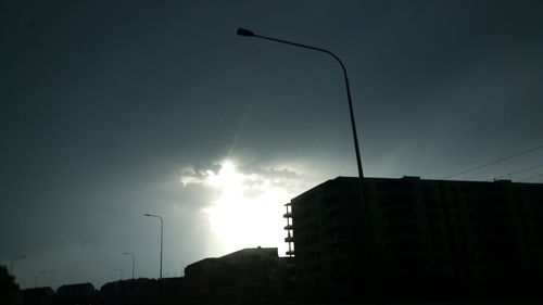 Low angle view of buildings against sky at sunset