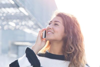 Portrait of smiling woman using mobile phone