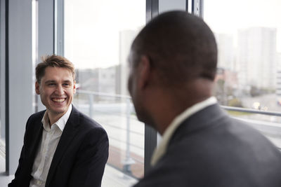 Smiling businessmen talking in office