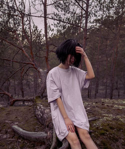 Full length of woman standing in forest