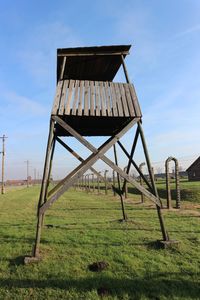 Built structure on field against sky