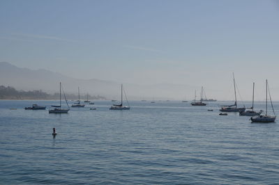 Boats on sea against sky