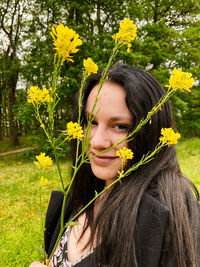 Portrait of beautiful woman with yellow flower