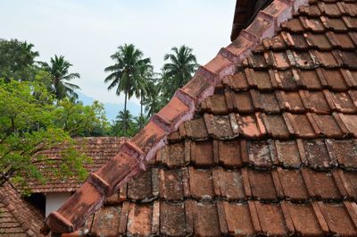 Low angle view of roof tiles against sky