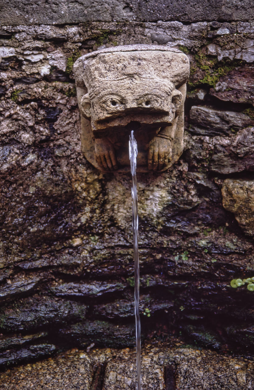 CLOSE-UP OF WATER FLOWING ON WALL