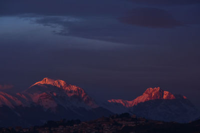 Scenic view of snowcapped mountains against sky during sunset