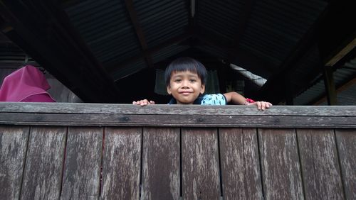 Portrait of cute girl standing on wood