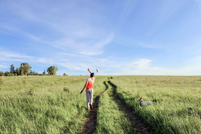 Man standing on field against sky