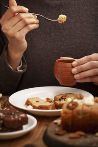 Midsection of woman eating breakfast