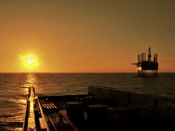 Scenic view of sea against orange sky