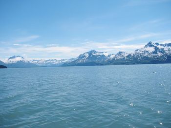 Scenic view of sea and mountains against sky