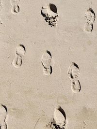 High angle view of footprints on sand