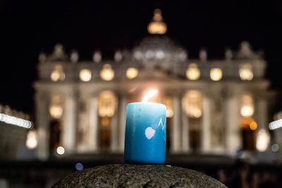 Lit candles in city at night