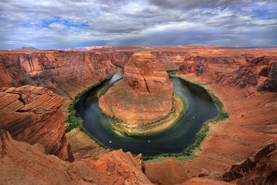 Aerial view of rock formations against cloudy sky