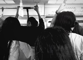 Rear view of women sitting in bus