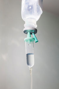 Close-up of iv drip against white wall